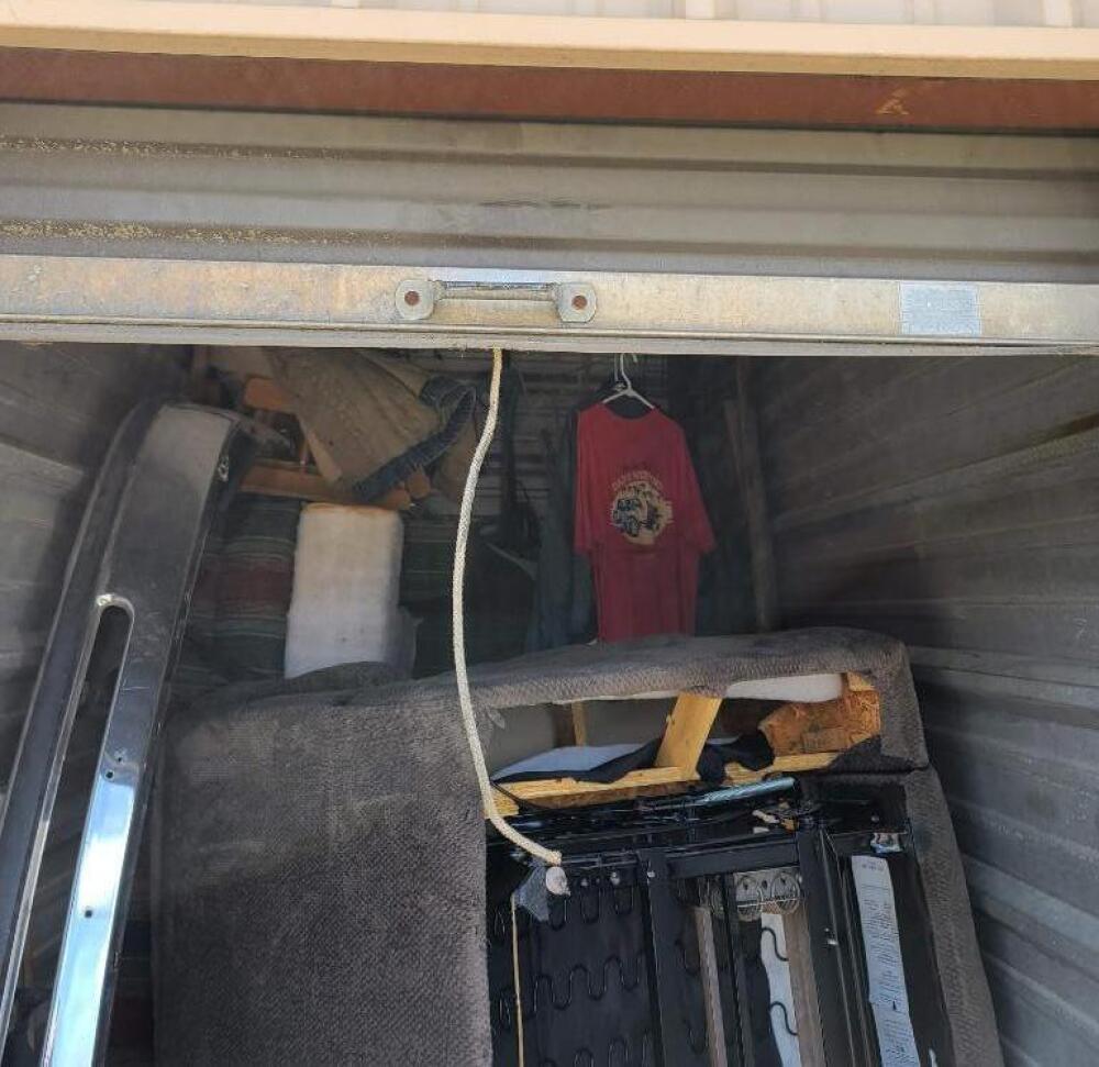 Contents of Unit - Love seat recliner - spool of wire - bumper - clothes - small trunk - couch