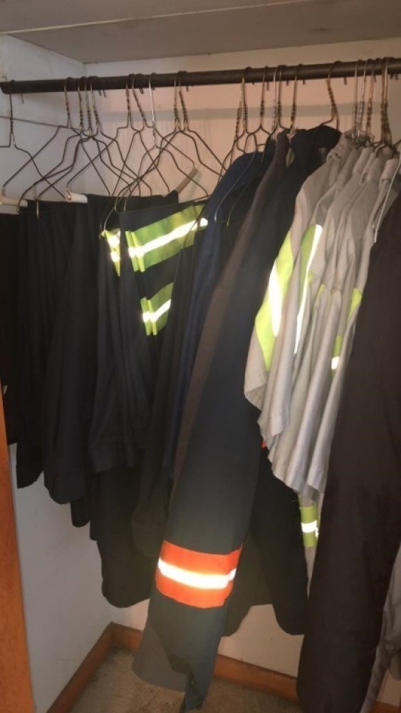 Contents of Closet: Uniforms of various sizes with Reflective strip