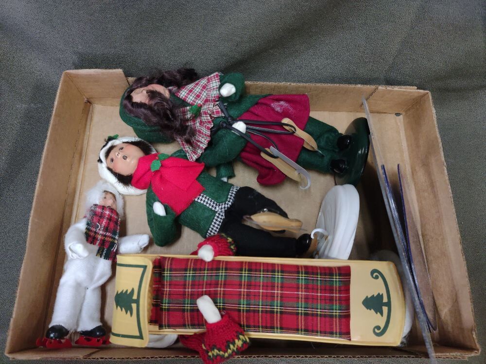 Four Byers' Choice Carolers and Skaters