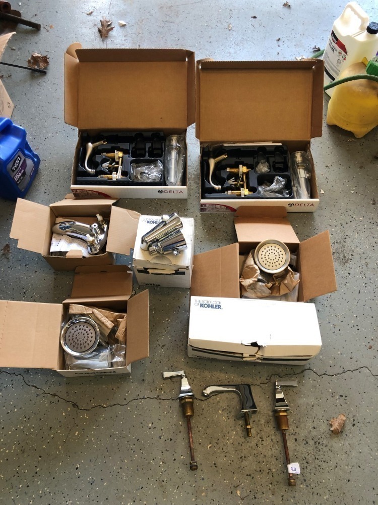 Assortment of Water Faucets, Handles, and Shower Heads.