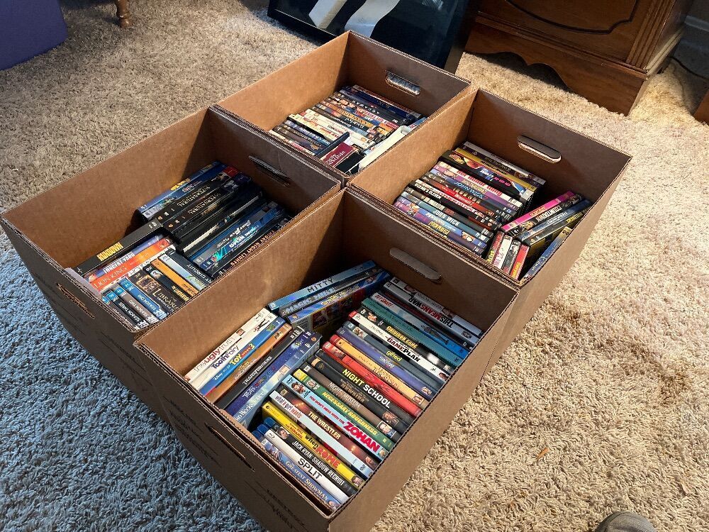 4 Boxes of Assorted DVDs
