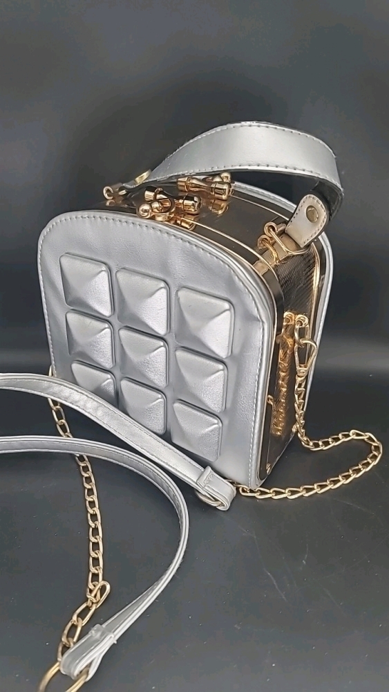 Silver and goldtone purse 6.5" X 3.5" X 6".Long strap or carry handle. Opens on both sides.