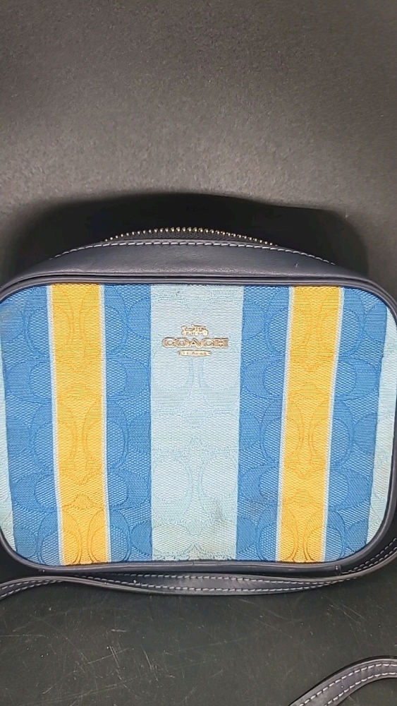Cross body purse. Says Coach but no interior tag with serial number. Shades of blue and goldenrod. 5.5" X 7" X 1.5" LONG strap is adjustable.