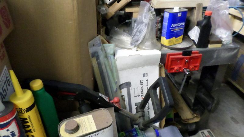 green metal shelf, black metal shelf, brown shelf & contents