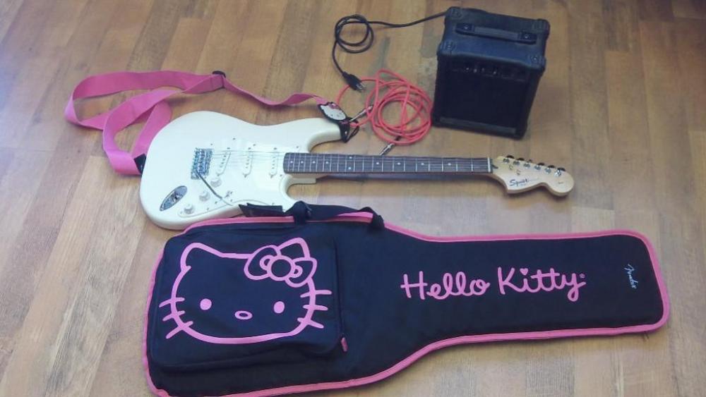 Squier Strat by Fender electric guitar with tuner, cord, Epoch G-10 amp & Hello Kitty carrying case