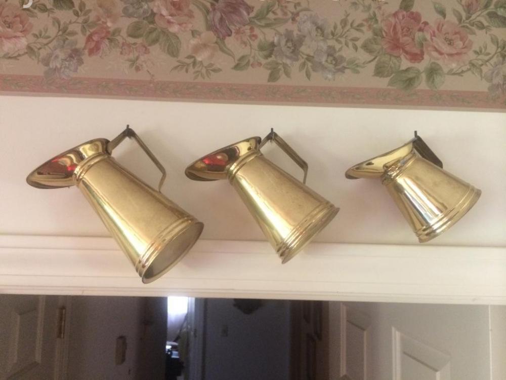 3 brass pitchers