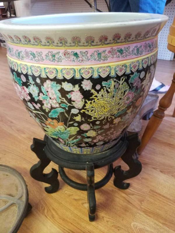 Plant stand with ceramic planter, 2 rolling plant stands, and 2 wooden plant stands