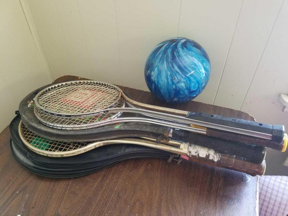 Assortment of tennis rackets and bowling ball