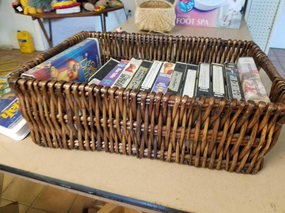 Assorted VHS movies and basket