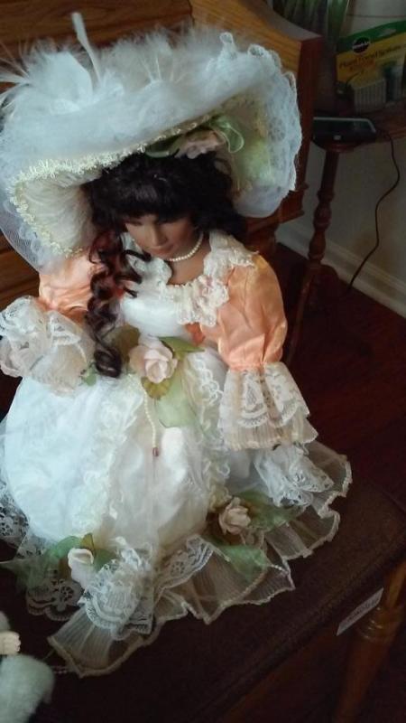 3 Porcelain Dolls, One holding Prigrim's Progress book is Jo from Little Women