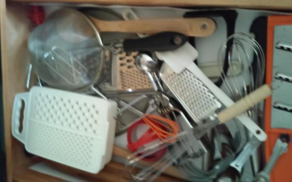 Contents of Drawer: Assortment of kitchen utensils
